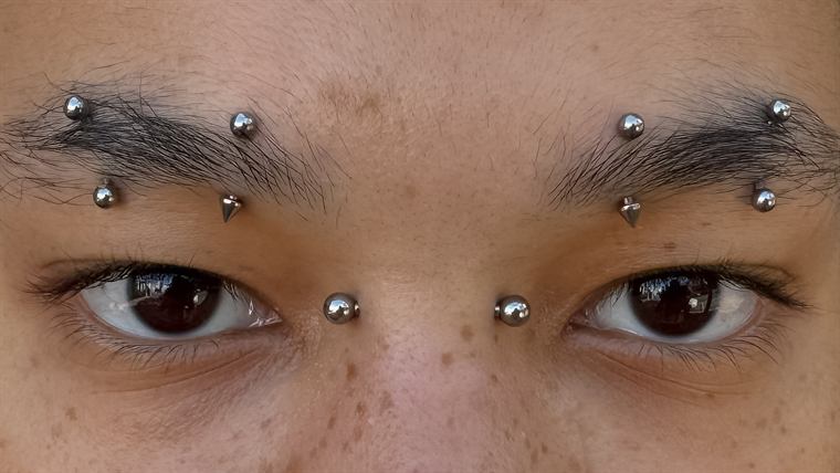 Sobrancelhas com piercings simétricos